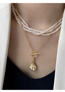 Detail of layered S925 silver pearl necklace with irregular coin pendant and OT buckle