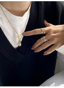Detail of S925 sterling silver OT buckle necklace with textured pendant and chic rings
