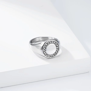 Macro shot of silver circular signet ring with micro-paved sparkling zircon halo edge