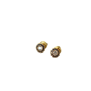 Elegant gold flower stud earrings with a white center stone and blue sapphire-style halo