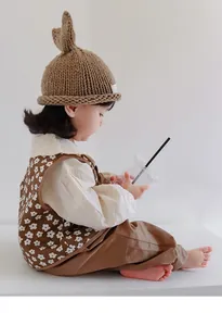 Toddler knitted set with white floral brown vest and matching rabbit ear knit hat
