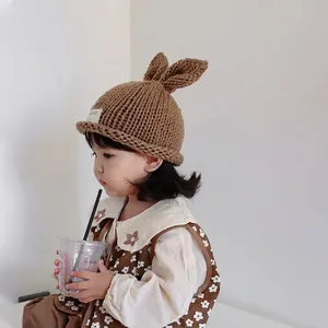 Handmade baby knitted hat with rabbit ears in brown for autumn and winter warmth
