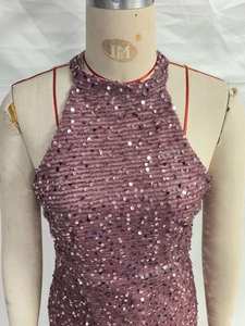 Detail of sequined halter neck dress with sparkling crystal fringe and refined knit texture