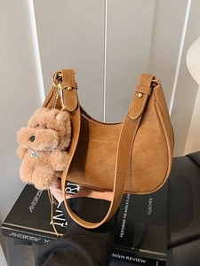 Caramel crescent underarm bag with VRCE & VIER gold logo and plush dog charm accessory