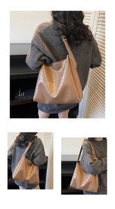 Detail view of brown crocodile texture on a large capacity vintage hobo shoulder bag