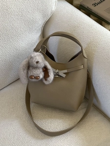 Minimalist khaki lychee grain leather bucket bag with silver buckle and rabbit charm