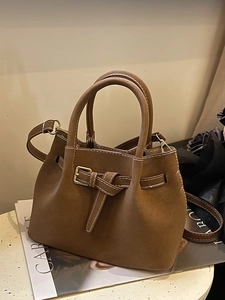Chic brown suede bucket bag with dual handles and long shoulder strap for 2025 fashion