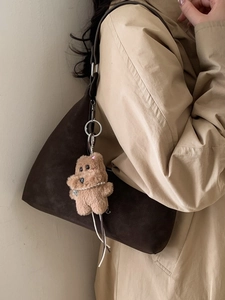 Large coffee brown suede tote bag with dog charm shown on model in beige coat