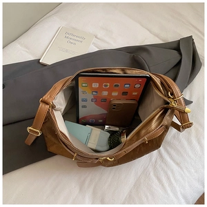Close-up of brown tote bag interior showing large capacity for tablet and essentials