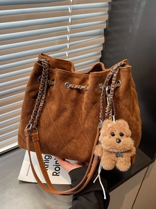 Vintage brown suede bucket bag with quilted diamond pattern and chain straps