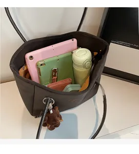 Internal view of brown tote bag showing capacity for tablet, water bottle and wallet