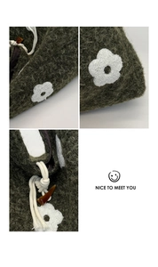 Detailed macro view of olive green fuzzy tote bag with floral embroidery and toggle button