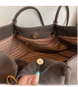 Detail view of large tote bag interior featuring striped lining and secure magnetic snap