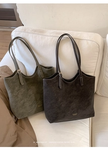 Close-up of retro matte leather tote bags with brand embossing and metallic buckle details