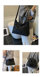 Detail of adjustable black tote bag showing metal buckle for shoulder and backpack styles