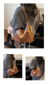 Detailed view of large vintage brown hobo bag with wooden bead charm and clear texture
