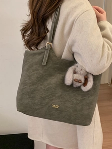 Vintage green tote bag for women with plush bunny charm and adjustable shoulder straps
