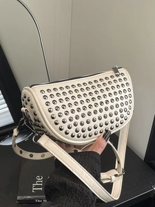 White semi-circular rivet crossbody bag with silver studs and adjustable strap