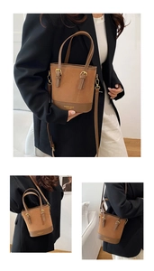 Detail of vintage bucket bag with dual-texture contrast leather and gold metal buckle