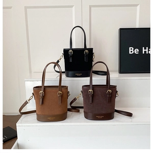 Three bucket bags in black, brown and coffee featuring suede and leather patchwork detail