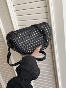 Punk style black leather studded crossbody barrel bag with silver metal rivets