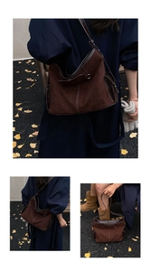 Detail of vintage brown suede tote bag with contrast stitching and thin leather strap