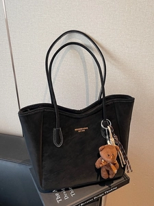 Minimalist large black tote bag with white stitching and cute teddy bear charm