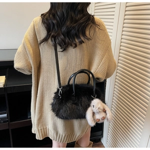 Faux fur shell handbag in black with plush rabbit charm and crossbody strap