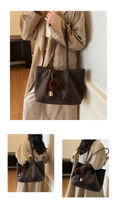 Three views of a brown leather tote bag with a plush charm and gold logo detail