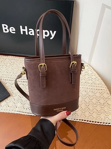 Vintage dark brown color-block bucket bag with gold hardware and adjustable strap