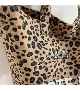 Close-up of leopard print canvas tote bag fabric texture with TOTE lettering detail