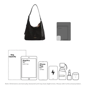 Detail view showing the large capacity of a black hobo bag fitting an 11-inch tablet and phone