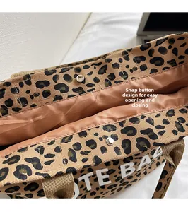 Detail showing the snap button closure and interior lining of the leopard print tote bag