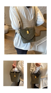 Detail of olive green bucket bag showing gold hardware and adjustable crossbody strap