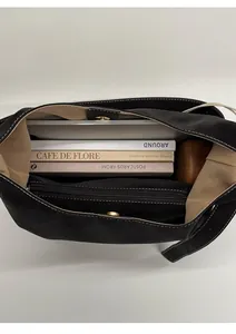 Top view of large black leather tote bag showing spacious interior with zipper pocket
