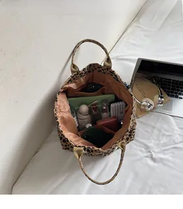 Leopard print tote bag interior showing large capacity for laptop and cosmetics