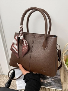 Large dark brown pebble leather bucket bag with silk scarf detail and crossbody strap