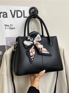 Black litchi leather bucket bag with decorative printed scarf and dual handles