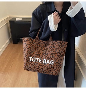 Close-up of leopard print canvas tote bag with Tote Bag text and sturdy handles