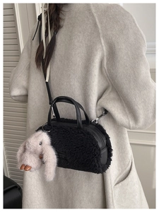 Detail of black faux fur mini Boston bag with plush bunny charm and fashion logo