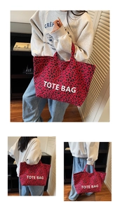 Detailed view of large red leopard print canvas tote bag with white TOTE BAG lettering