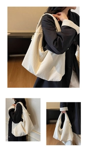 Detail of white large canvas tote bag showing soft texture and knotted zipper accents