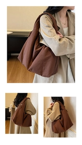 Detail view of coffee brown puffy tote bag with smooth texture and zipper detail