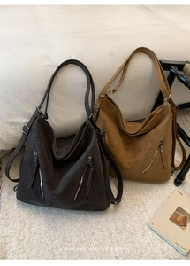 Detail of vintage tote bags in coffee and caramel colors with textured faux leather