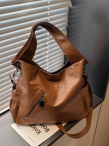 Brown vintage faux leather tote bag with wide strap and spacious design for women