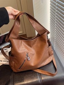 Brown faux leather large capacity hobo shoulder bag with crossbody strap and metal buckle