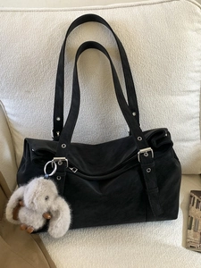 Large capacity black suede tote bag with cute rabbit pendant on white sofa