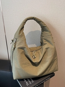 Large army green canvas tote bag with functional zippers and woven knots for casual look