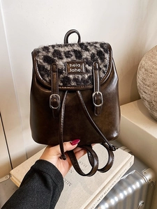Vintage bruine leren rugzak met luipaardprint flap getoond in een lifestyle reisomgeving