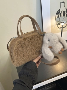 Brown faux shearling cylinder handbag with leather handles and cute bunny keychain charm
